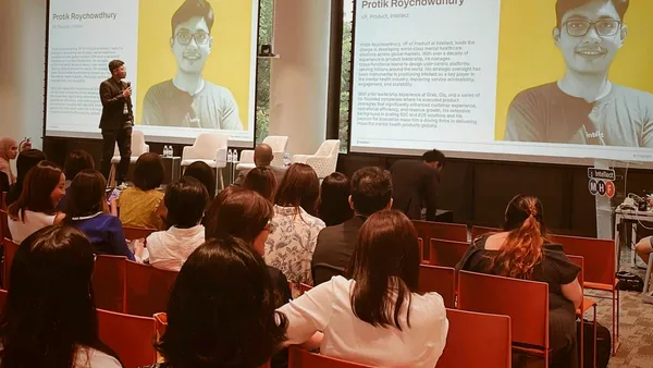 Protik Roychowdhury speaking on stage